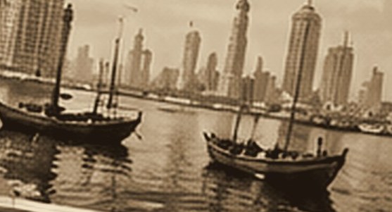Sepia photograph of dhows on Dubai Creek